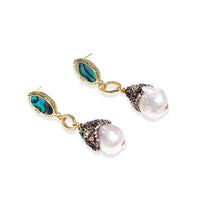 Gold drop earrings with iridescent abalone studs, rope links, jeweled caps and white baroque pearls on cream background